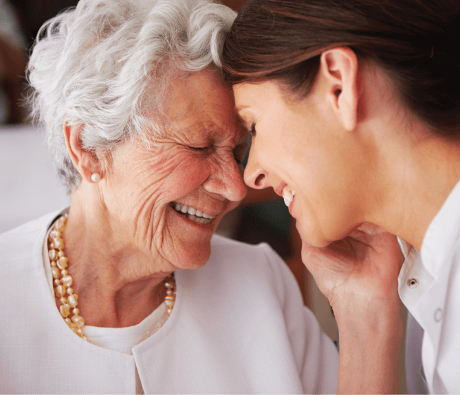 senior woman smiling at nurse
