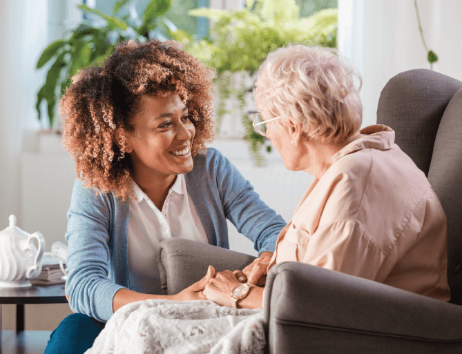 staff member visiting with a senior woman