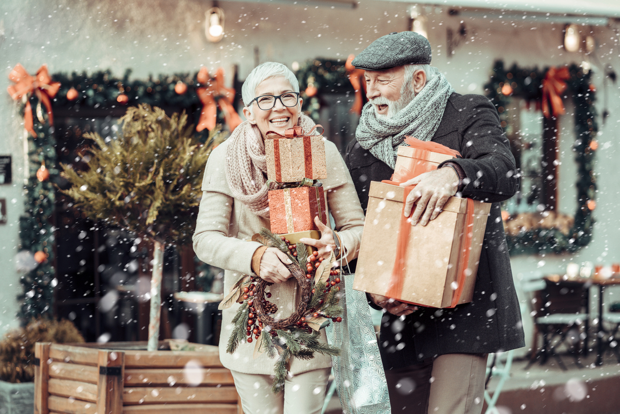 Senior couple at Christmas shopping, holding present's and gift boxes