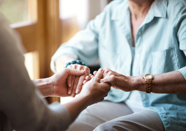 holding seniors hands